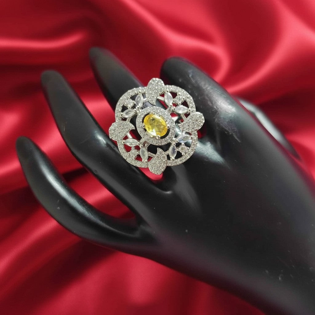 Shangri floral American Diamond ring featuring a yellow centre stone on a black display hand against red silk