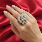 Shangri floral American Diamond ring featuring a yellow centre stone on an adjustable band, worn on a hand against red silk.