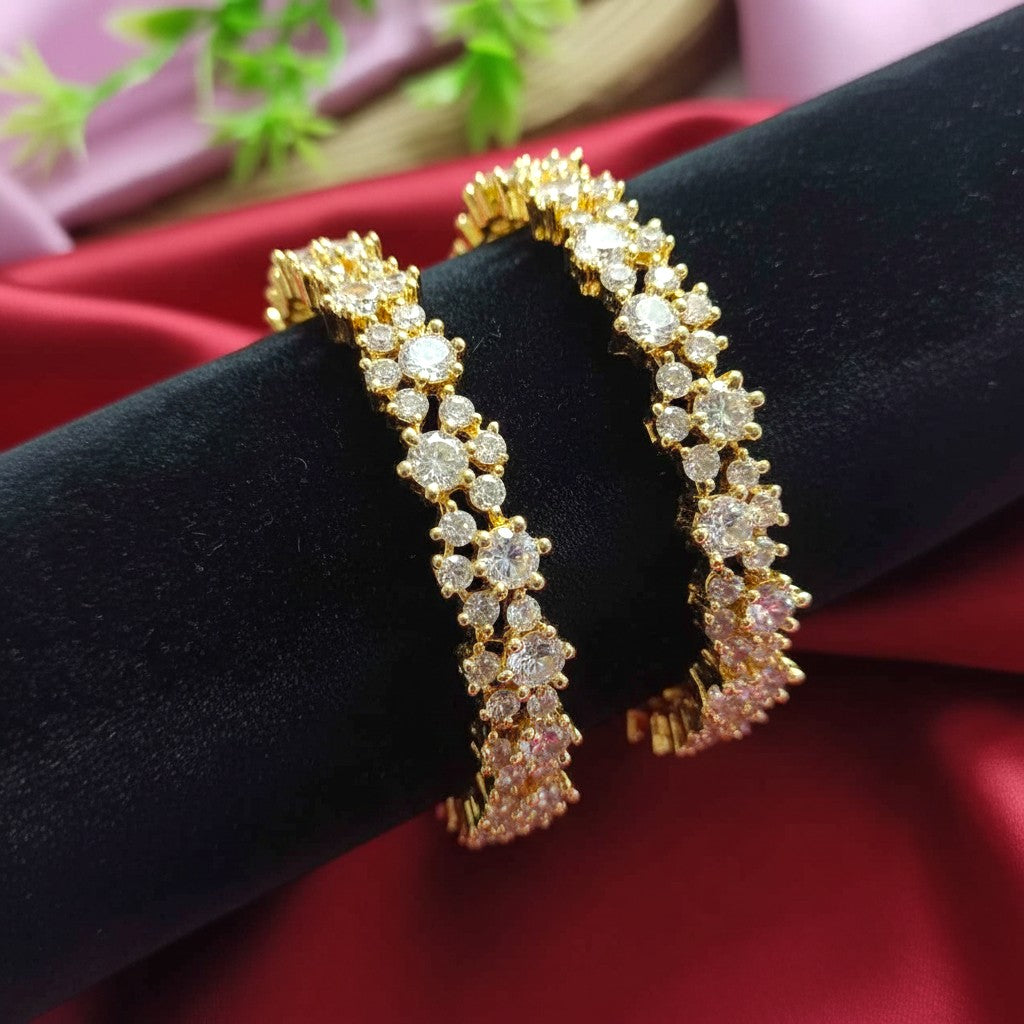 Shangri gold polish American Diamond bangles featuring sparkling stones in an elegant pattern for festive wear.