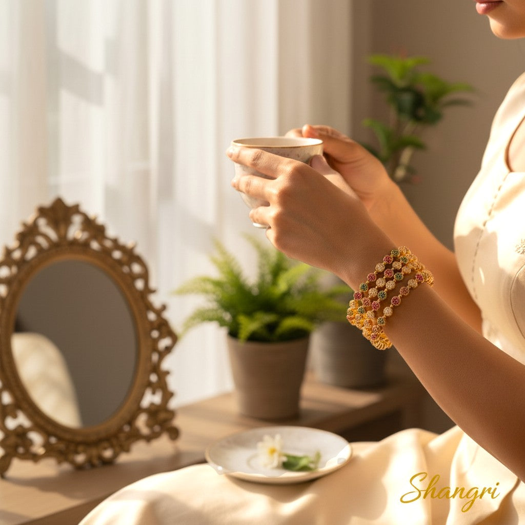 Shangri gold-plated bangles with white, red, and green AD stones in a circular design. Set of 4.