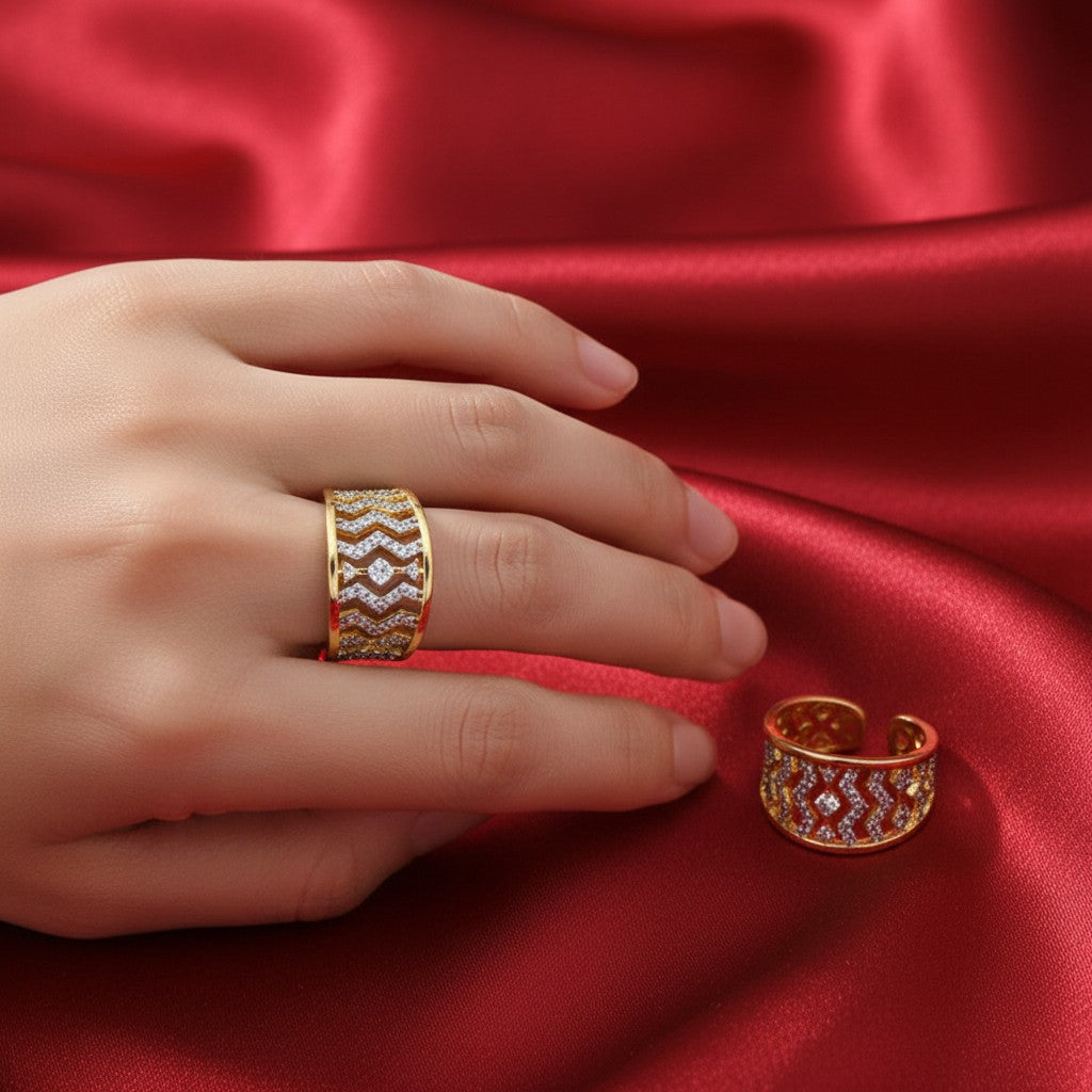 Shangri gold-plated cocktail ring with geometric Austrian stone pattern worn on a hand against red satin fabric