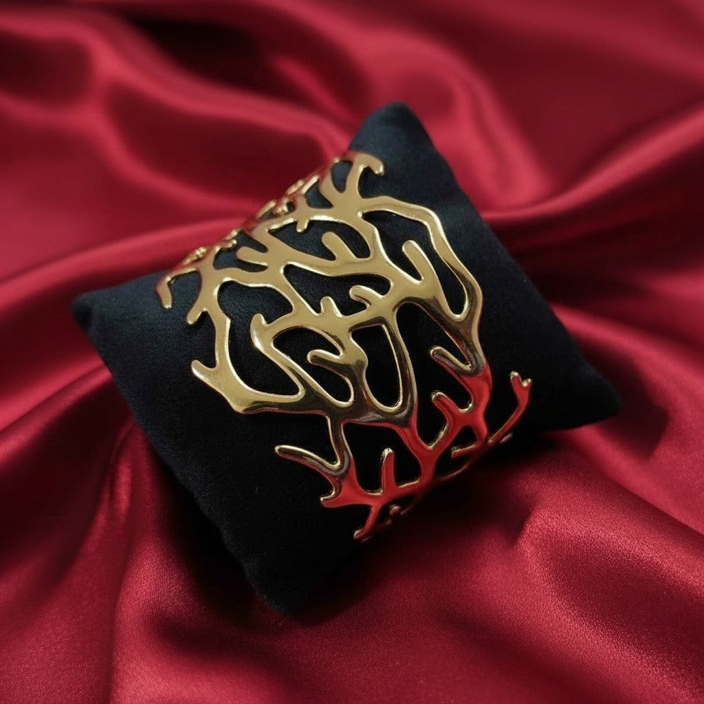 Shangri-La gold finish statement kada with abstract cut-out pattern, anti-tarnish material.
