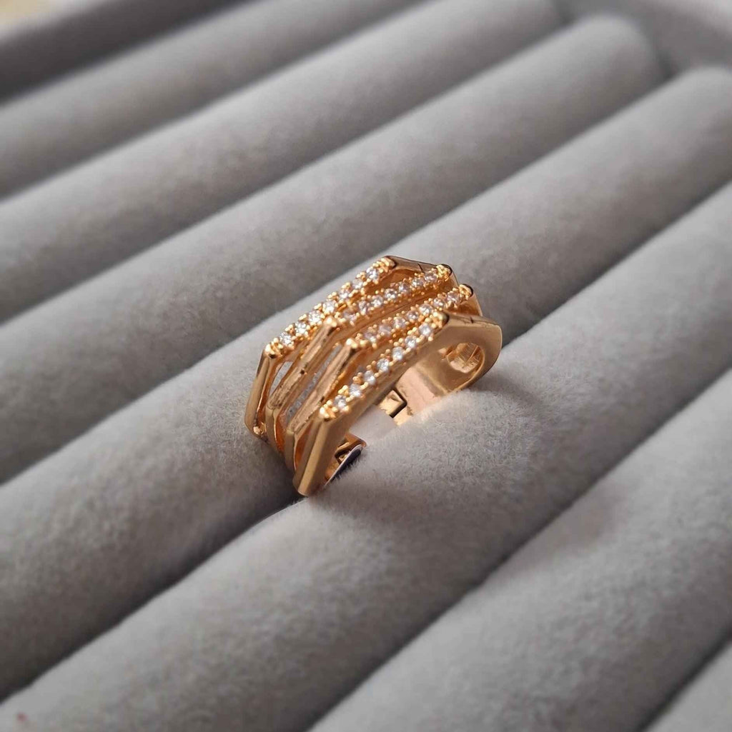 Shangri rose gold plated multi-band ring featuring sparkling Austrian stones on a grey velvet display