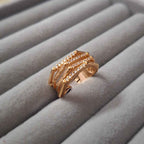 Shangri rose gold plated multi-band ring featuring sparkling Austrian stones on a grey velvet display