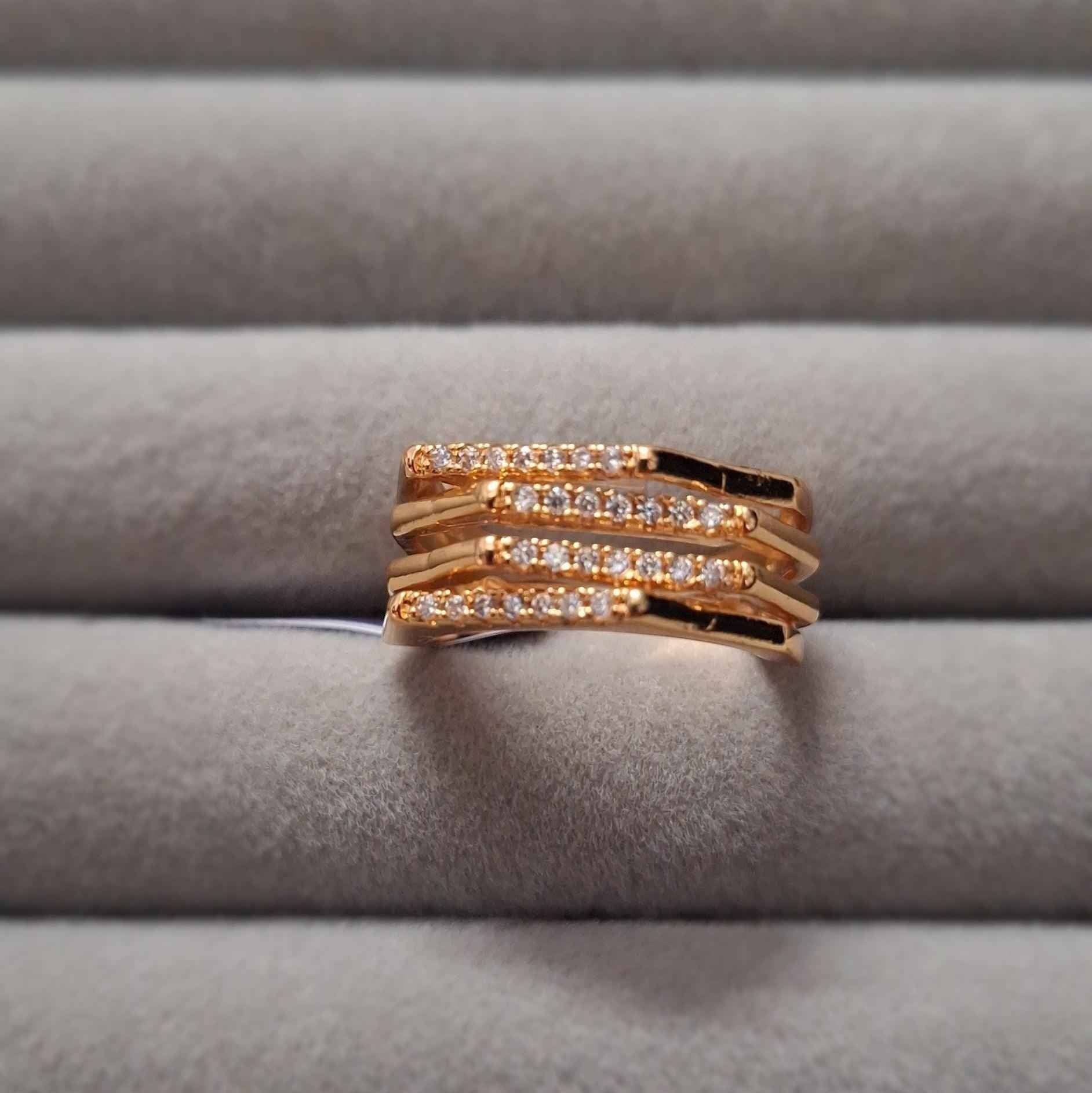 Shangri rose gold plated multi-band ring featuring sparkling Austrian stones on a grey velvet display