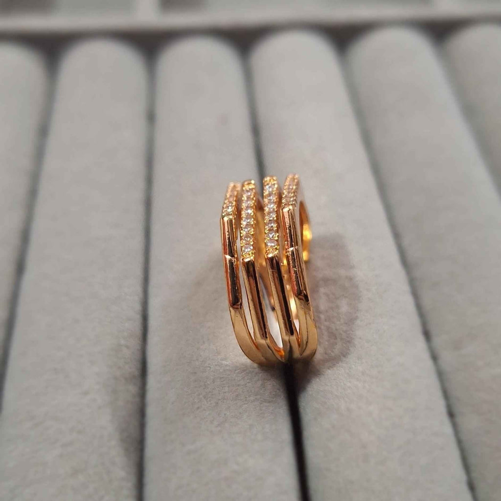 Shangri rose gold plated multi-band ring featuring sparkling Austrian stones on a grey velvet jewellery display.